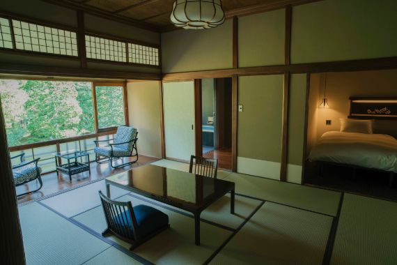 美しい深緑が広がる「松風」の部屋。源泉かけ流しの内湯、ベッドのついた和洋室タイプで、静寂に包まれた空間が心地良い。